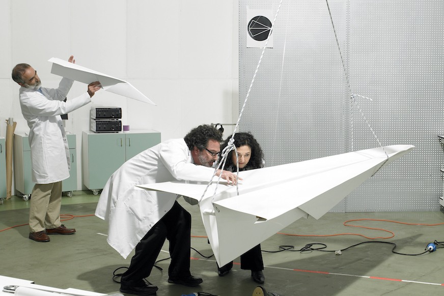 team of engineers designing giant paper airplanes