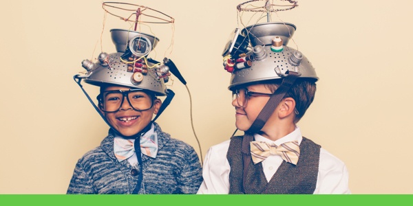 Two boys wearing hats made of strainers