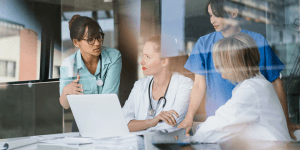 Doctors and Nurses Meeting Around a Laptop