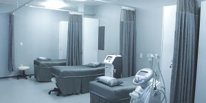 Grey Hospital Room With Beds and Machines