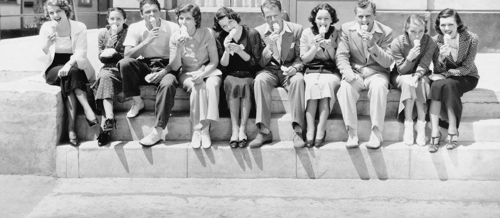 People from the mid-1900s eating ice cream on steps